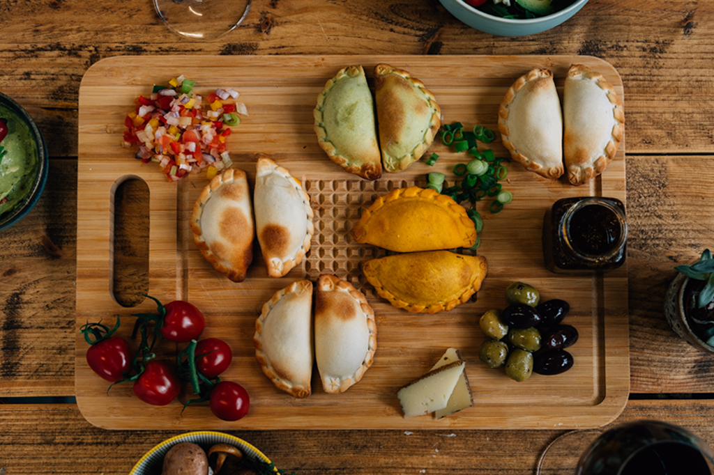 table full with Hola Empanada products